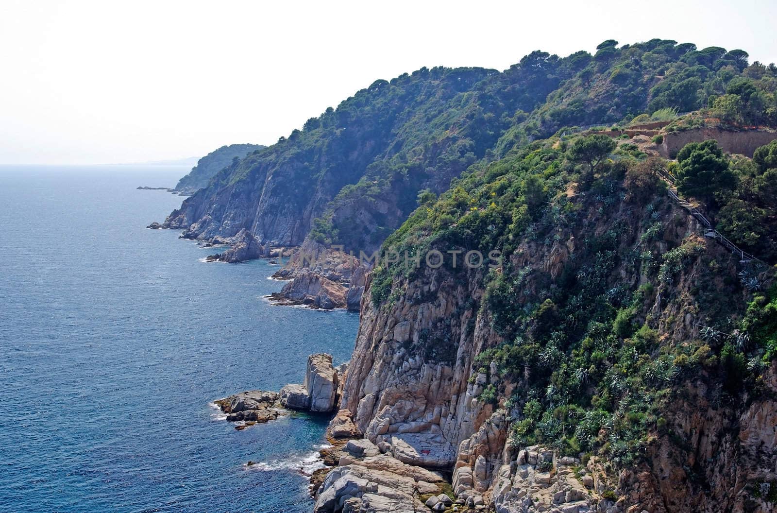 Sea and coastline with rocks. Lloret de Mar, Spain. by borodaev
