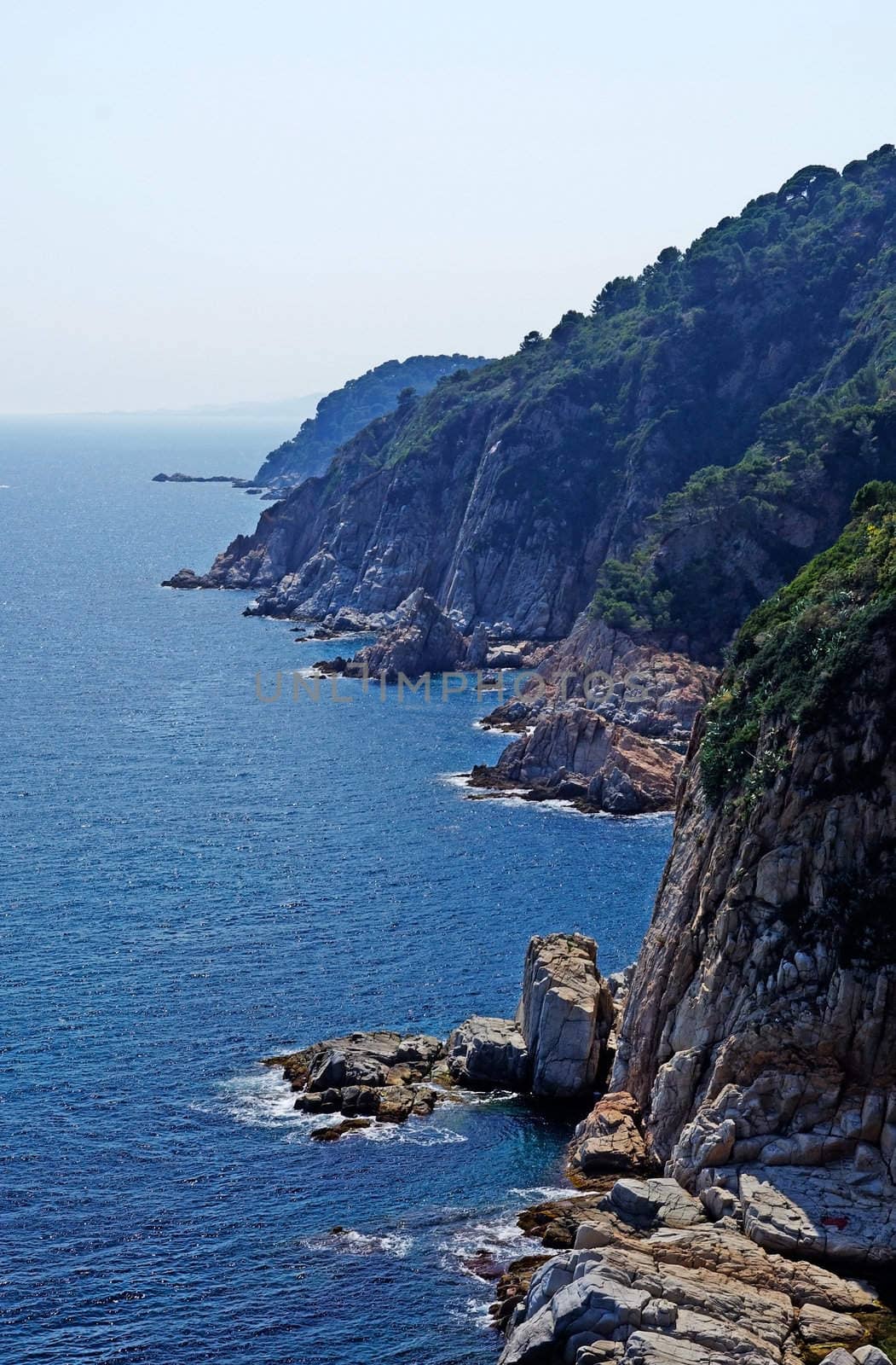 Vertical image of cliff and sea. Landscape of Lloret de Mar, Cos by borodaev