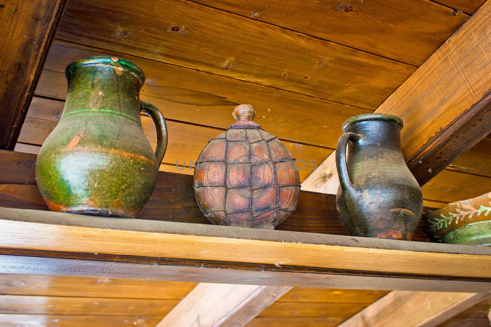 Two pots and copper canteen on wooden background
