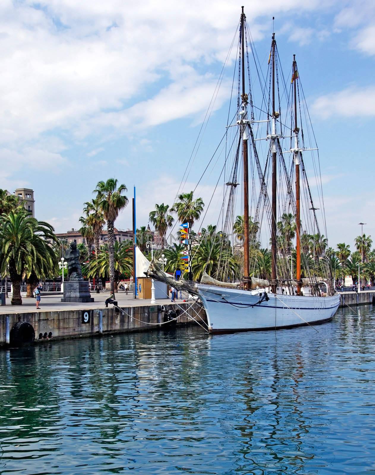 Big sailboat in Barcelona harbour for romantic travel. by borodaev