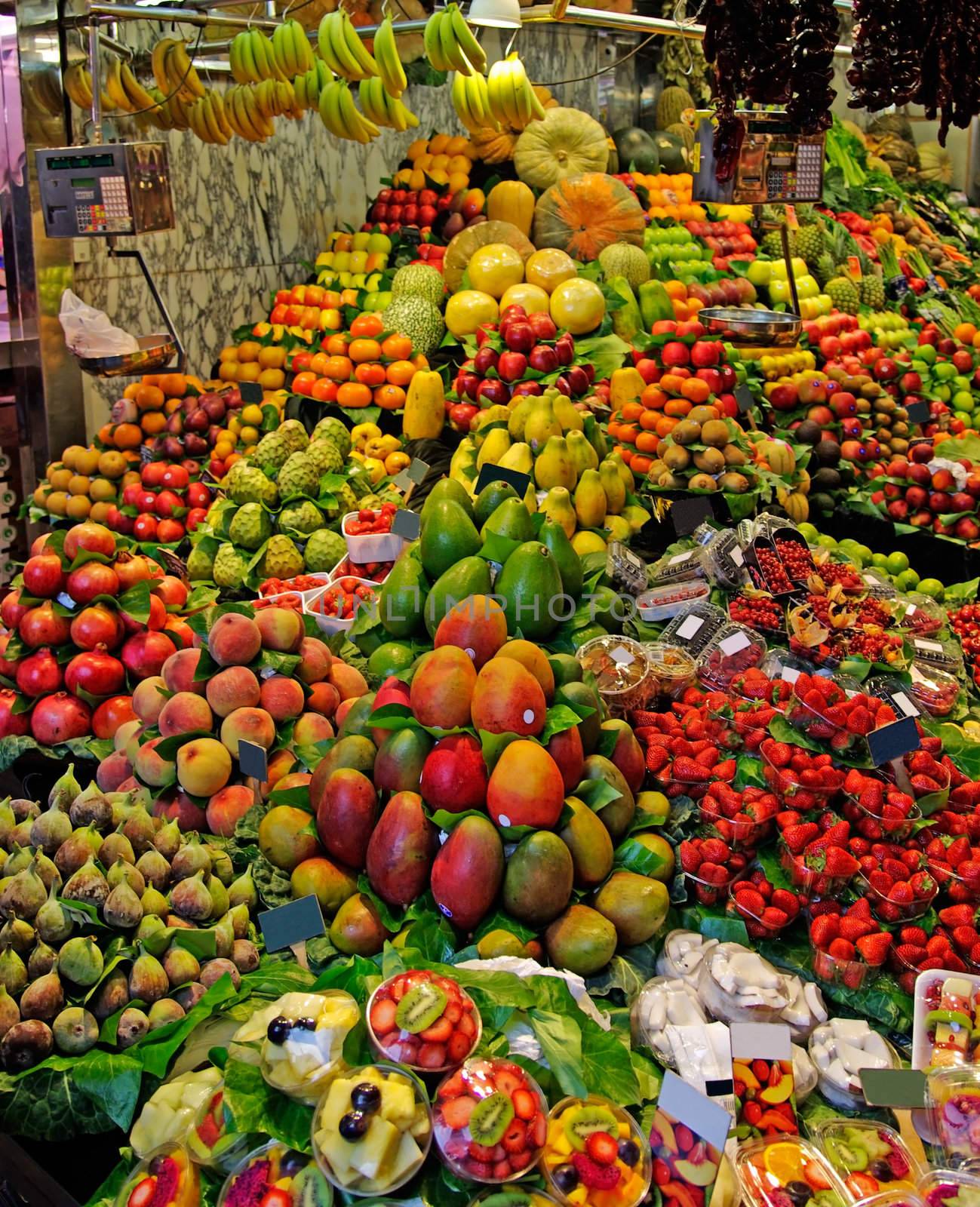 La Boqueria fruits stall. World famous Barcelona market, Spain. by borodaev