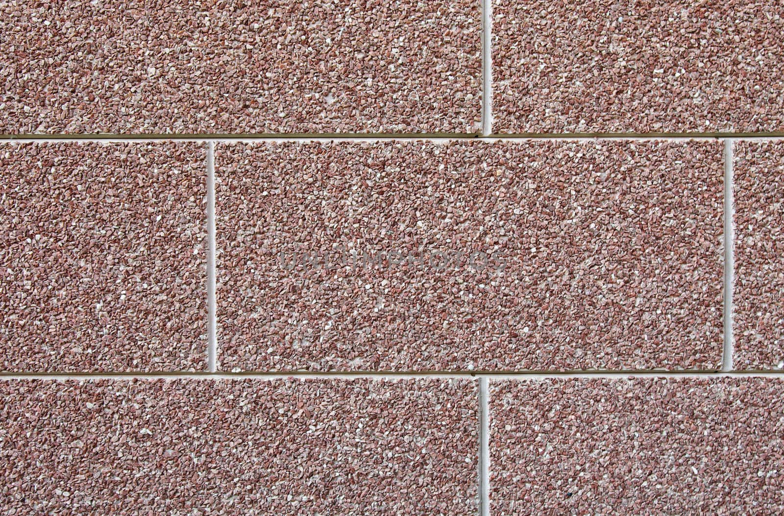 Abstract brown wall texture made of many small stones. by borodaev