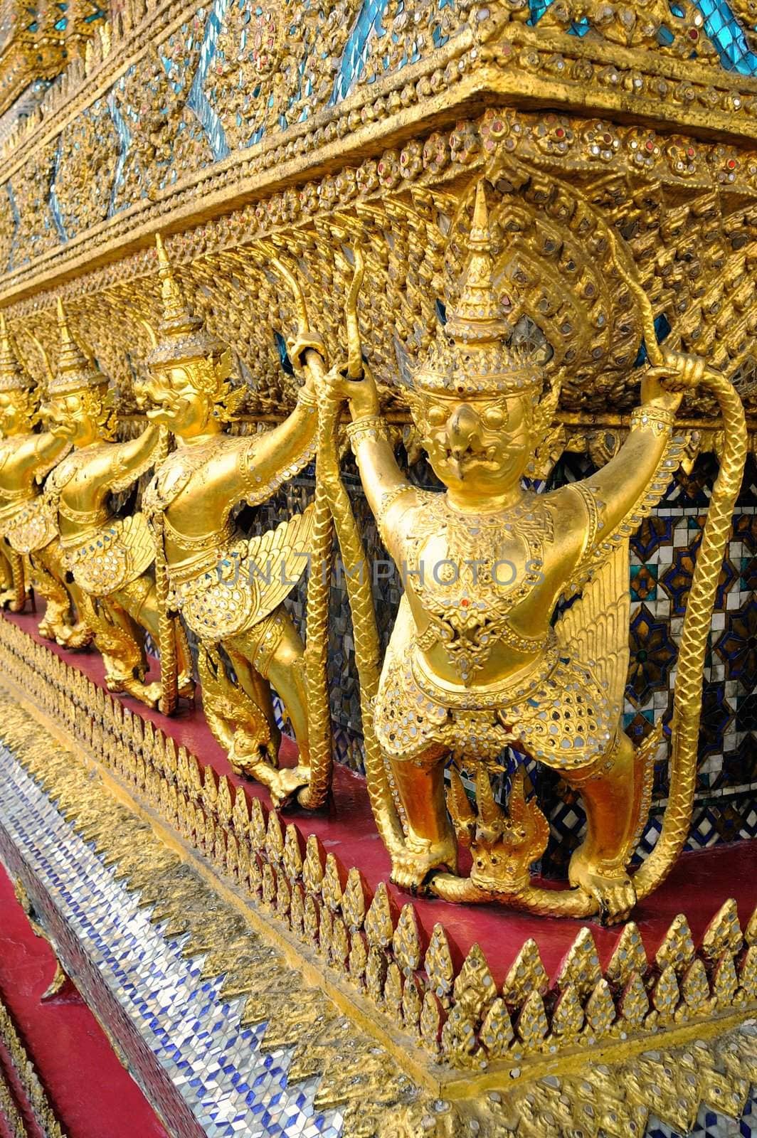 Gold ornamental patter statuettes in the Grand Palace. Temple of the Emerald Buddha, Thailand.
