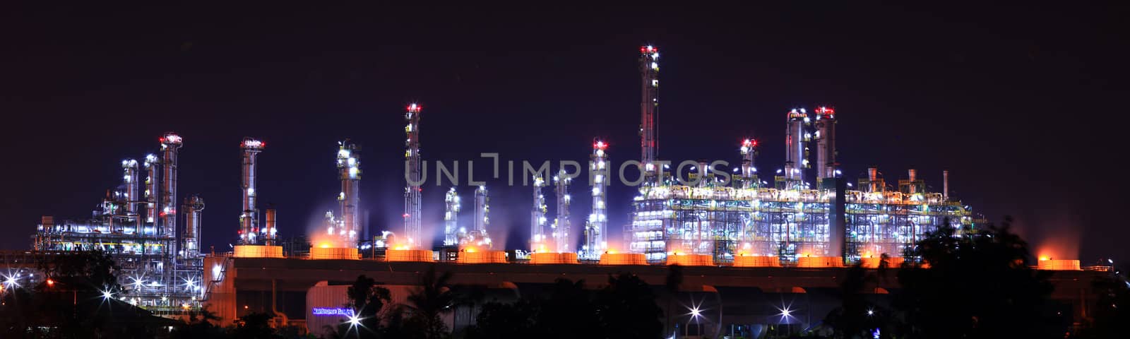 Panoramic view petrochemical oil refinery plant shines at night