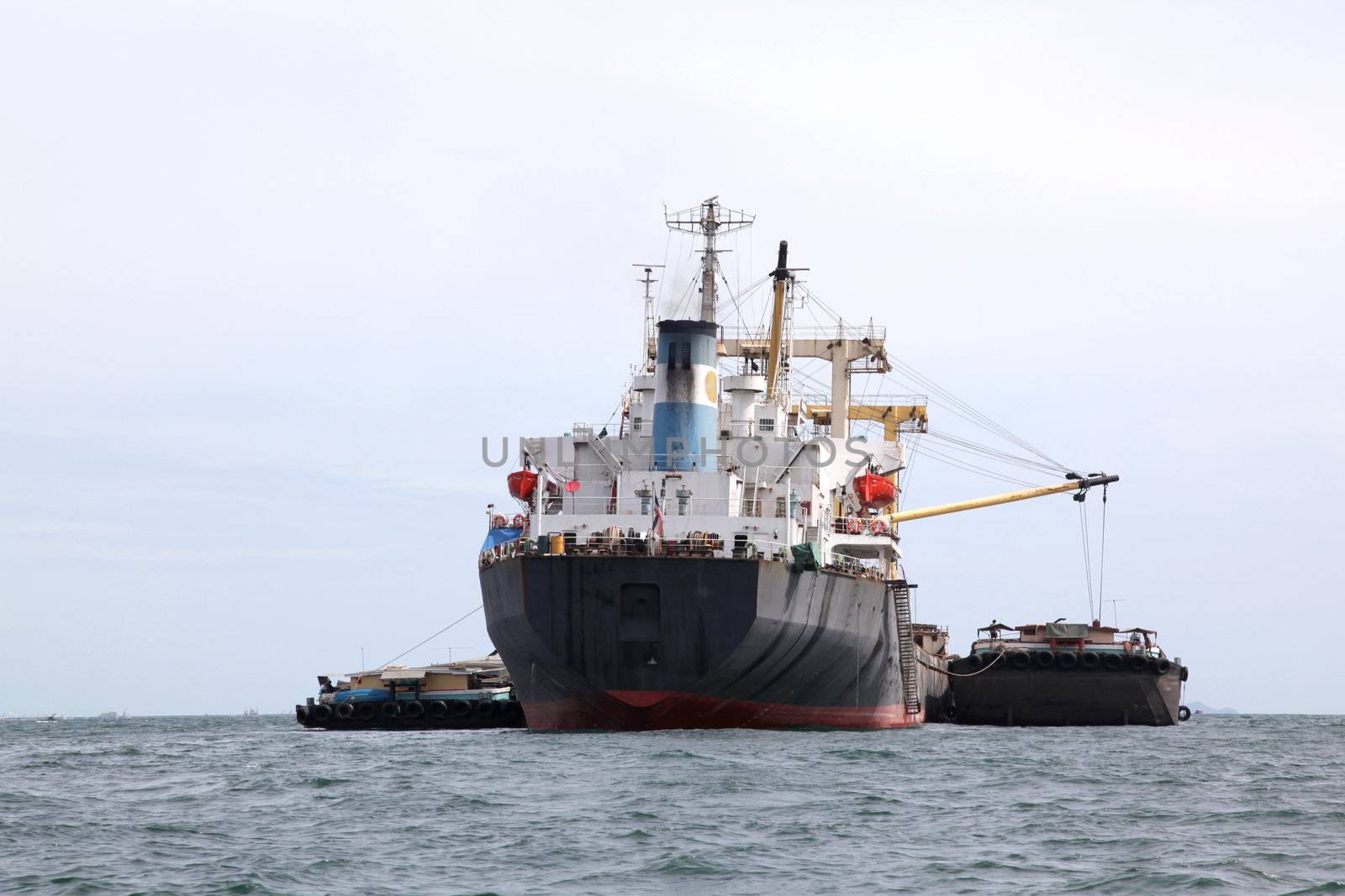 cargo liner freight Ship with containers and tug ship