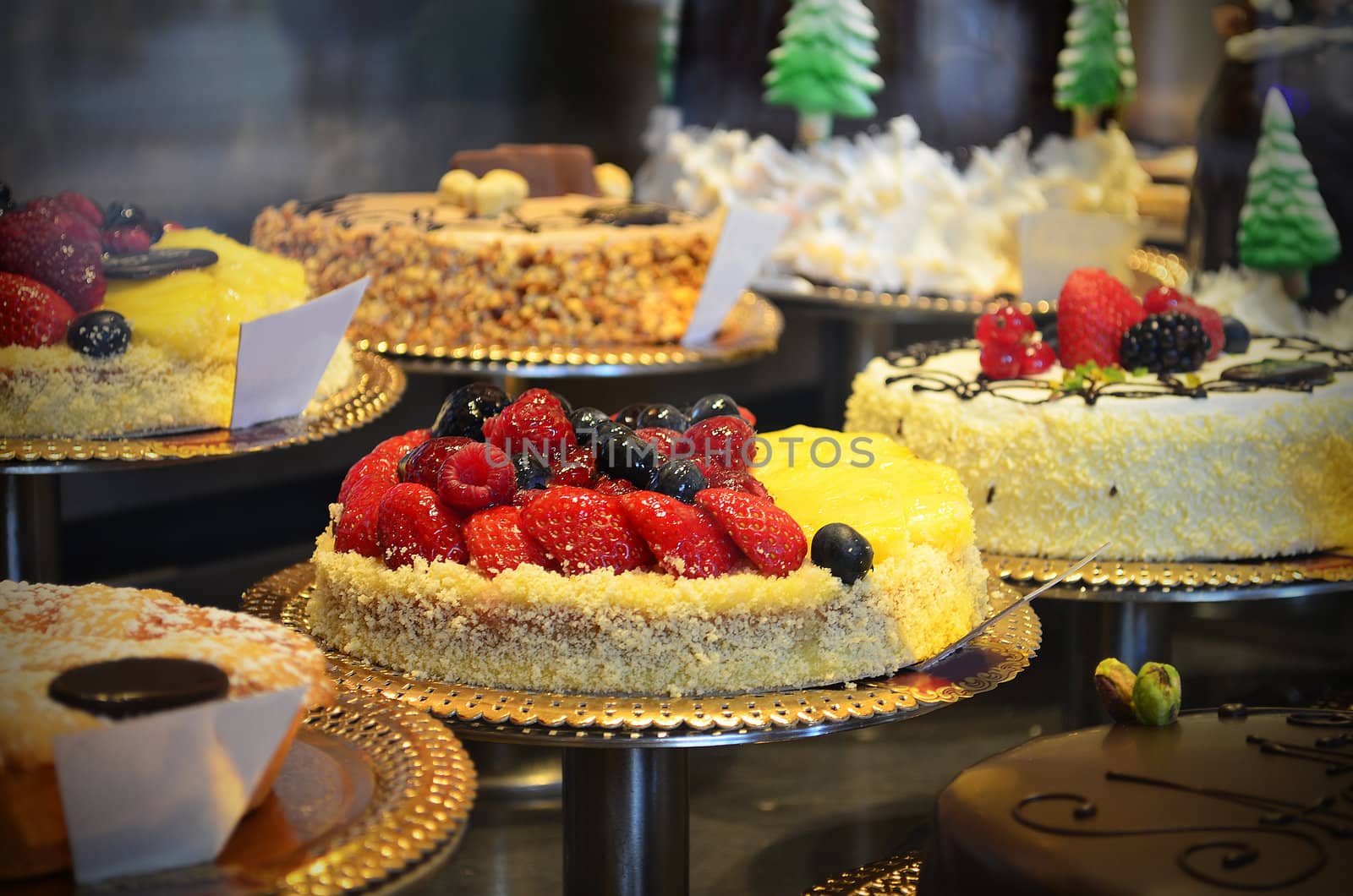Gourmet cakes in a shop window by artofphoto