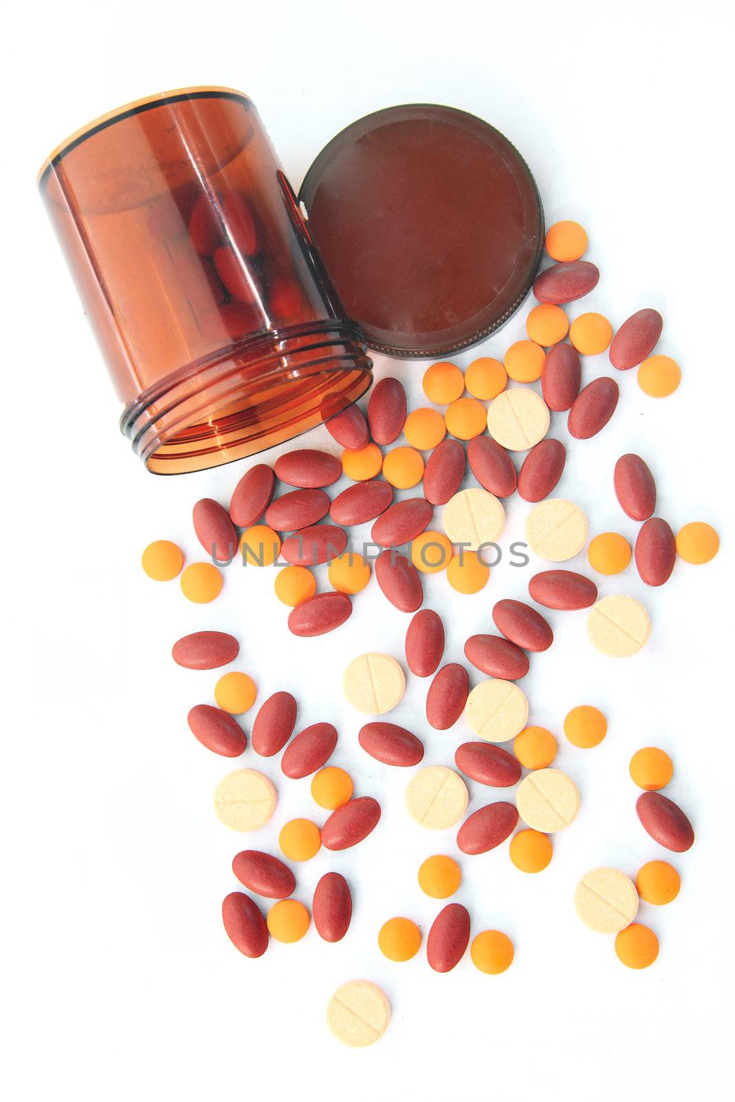isolated top Persepctive of Open pill bottle with medicine spilling out