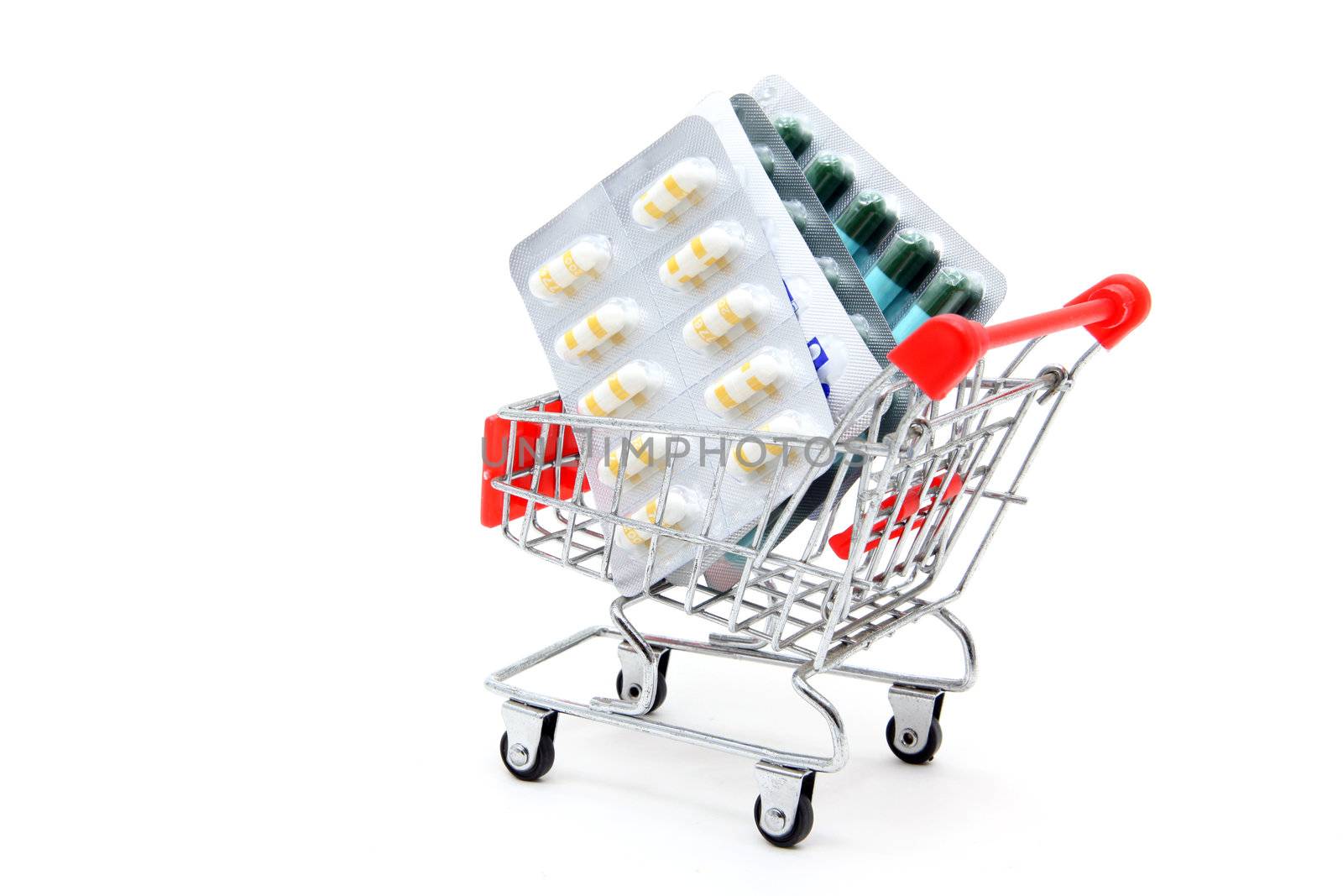 Capsules in shopping cart trolley for healthy concept