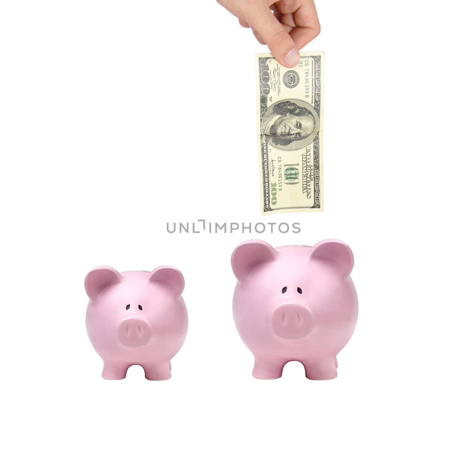 hand putting dollar bills into a pink piggy bank