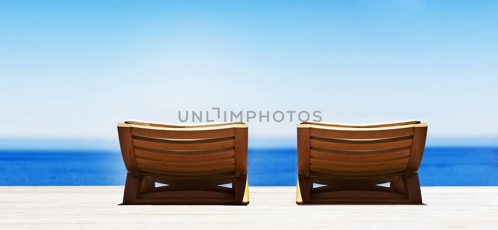 Beach chairs on perfect tropical sand beach by ozaiachin