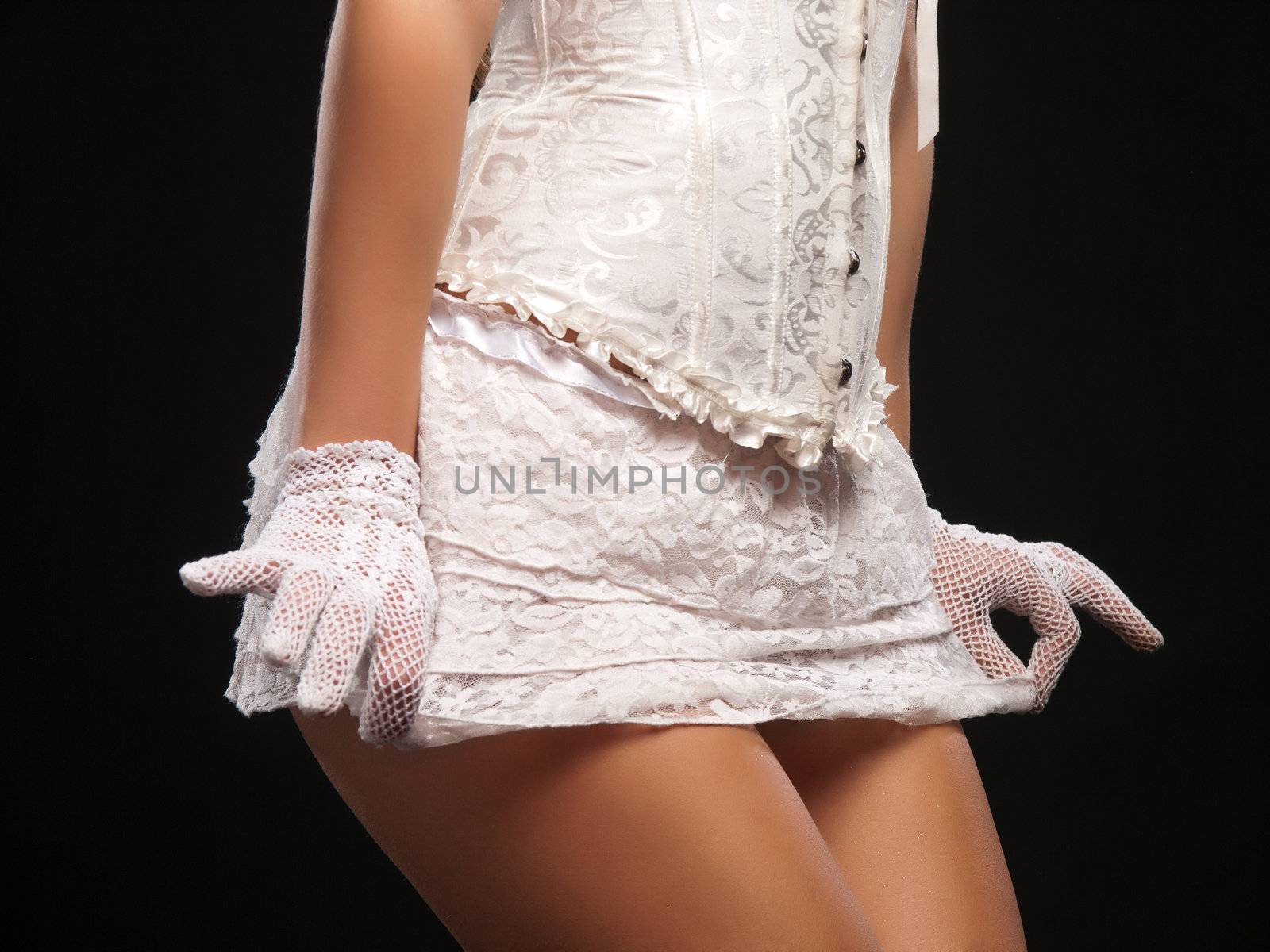 Female model wearing sexy white corset and miniskirt