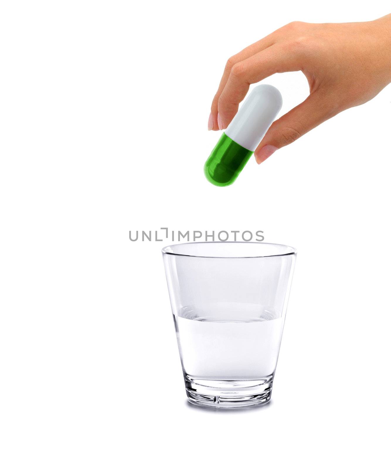 Hand and big pill with glass water - concept