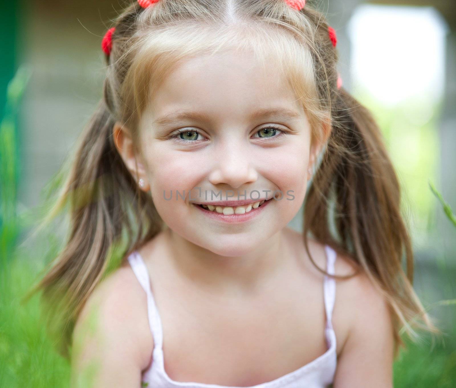 Portrait of a pretty little girl with bright smile