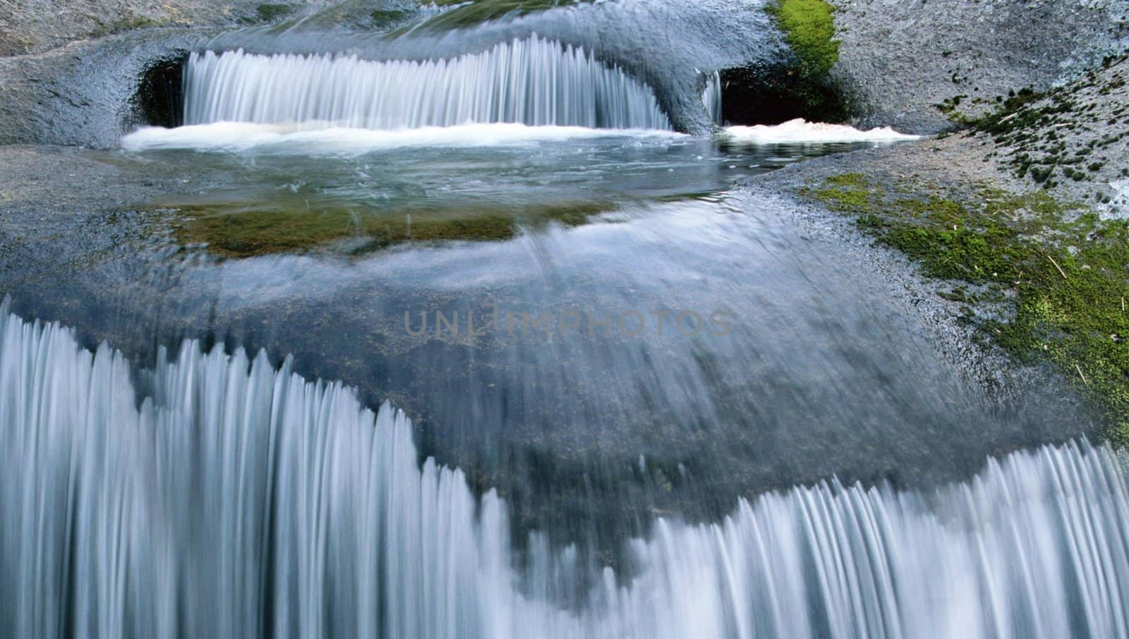 close up falling water by a spring