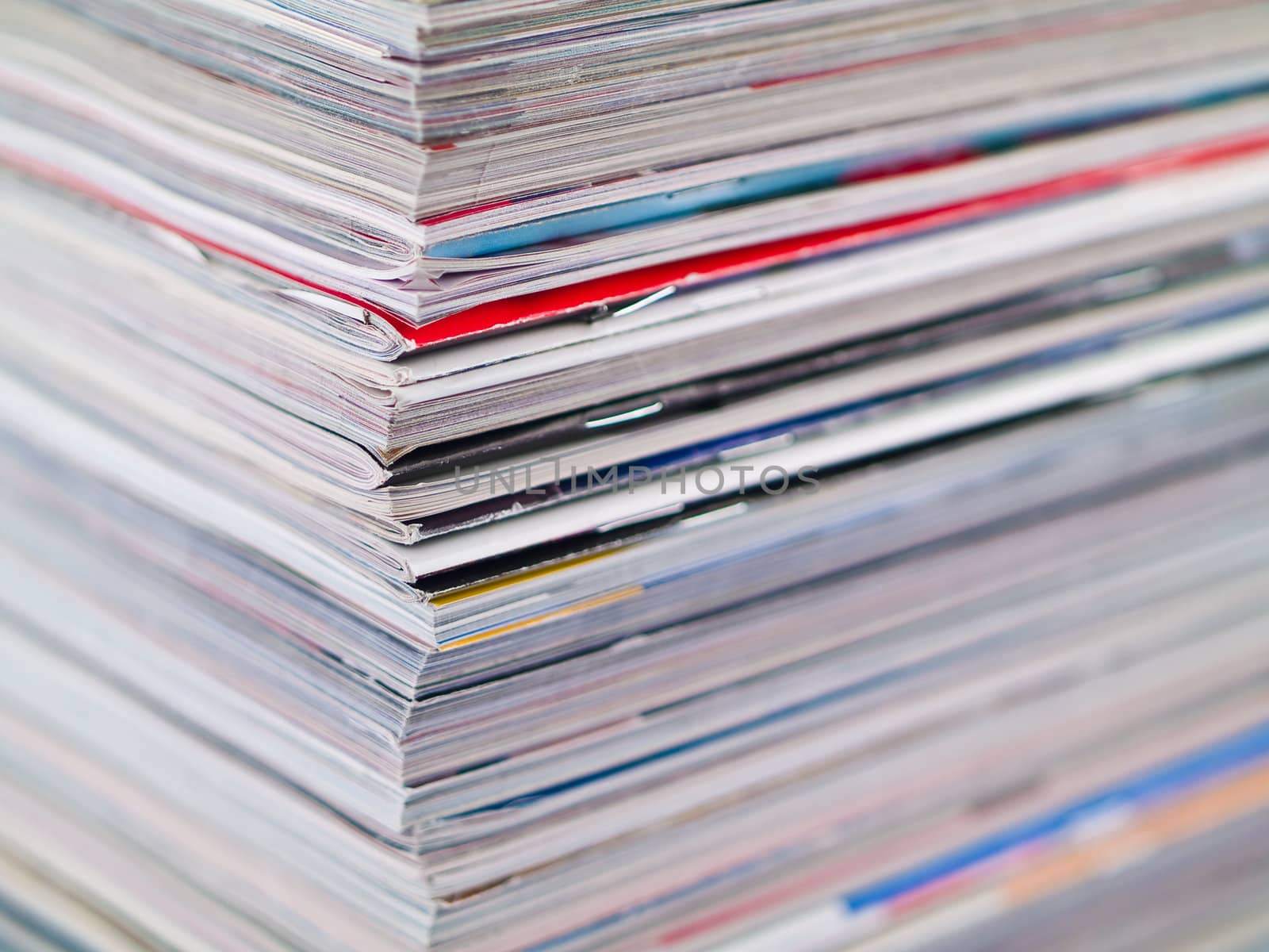 A stack of magazines filling the frame from top to bottom focus on corner edge