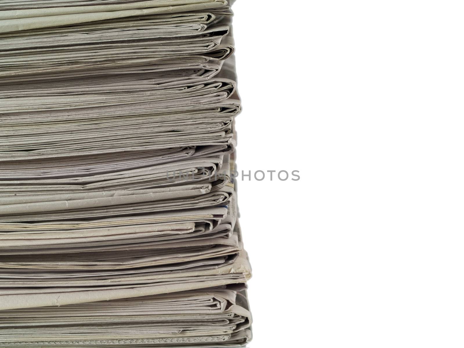 Old newspapers stacked from the top to bottom of the frame isolated on white