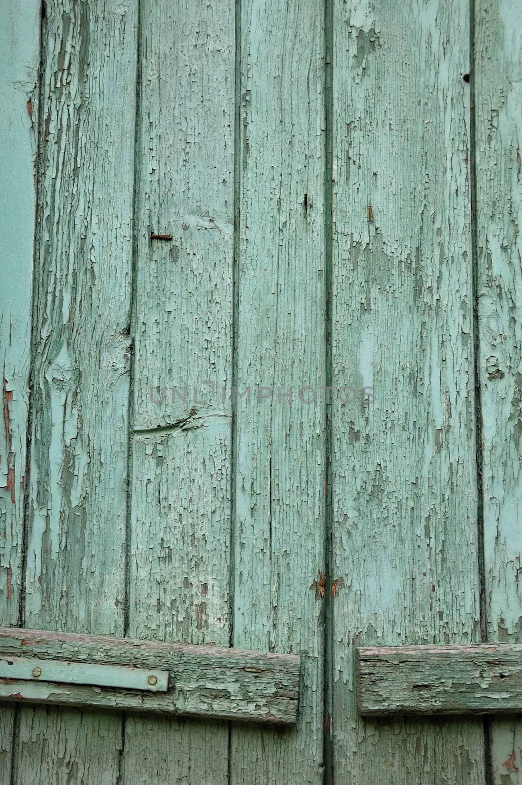 Window shutter with flaking paint. Abstract wood background.