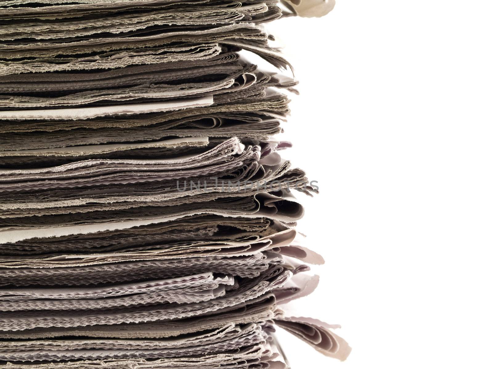 Old newspapers stacked from the top to bottom of the frame isolated on white