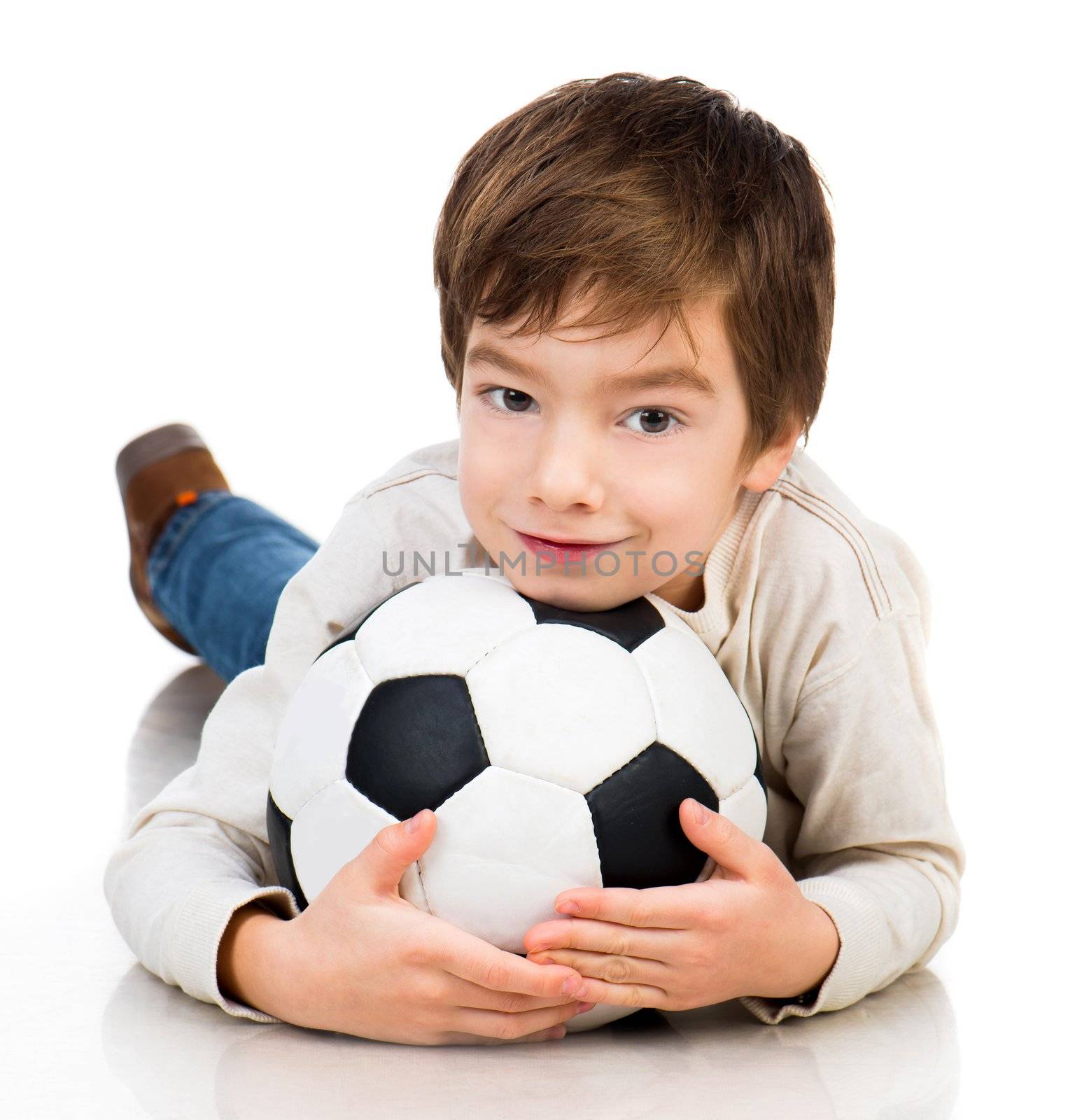Little boy soccer ball lying on white floor