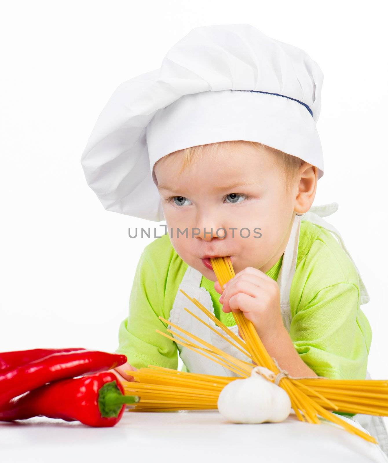 little boy with raw spaghetti