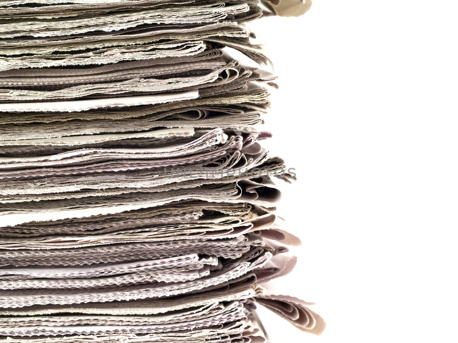 Old newspapers stacked from the top to bottom of the frame isolated on white