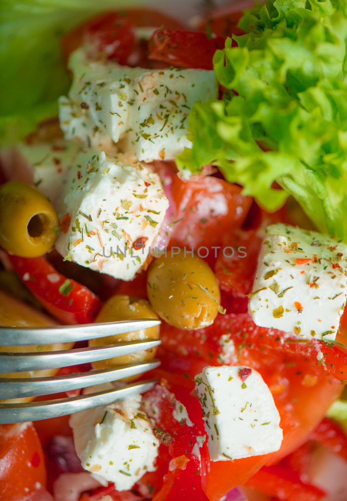 Greek salad on a plate with a spices
