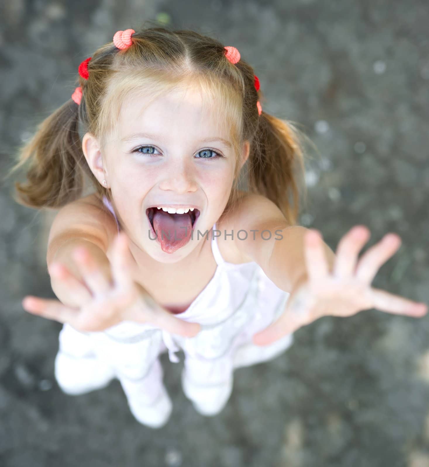 Portrait of smiling pretty little girl with hands up