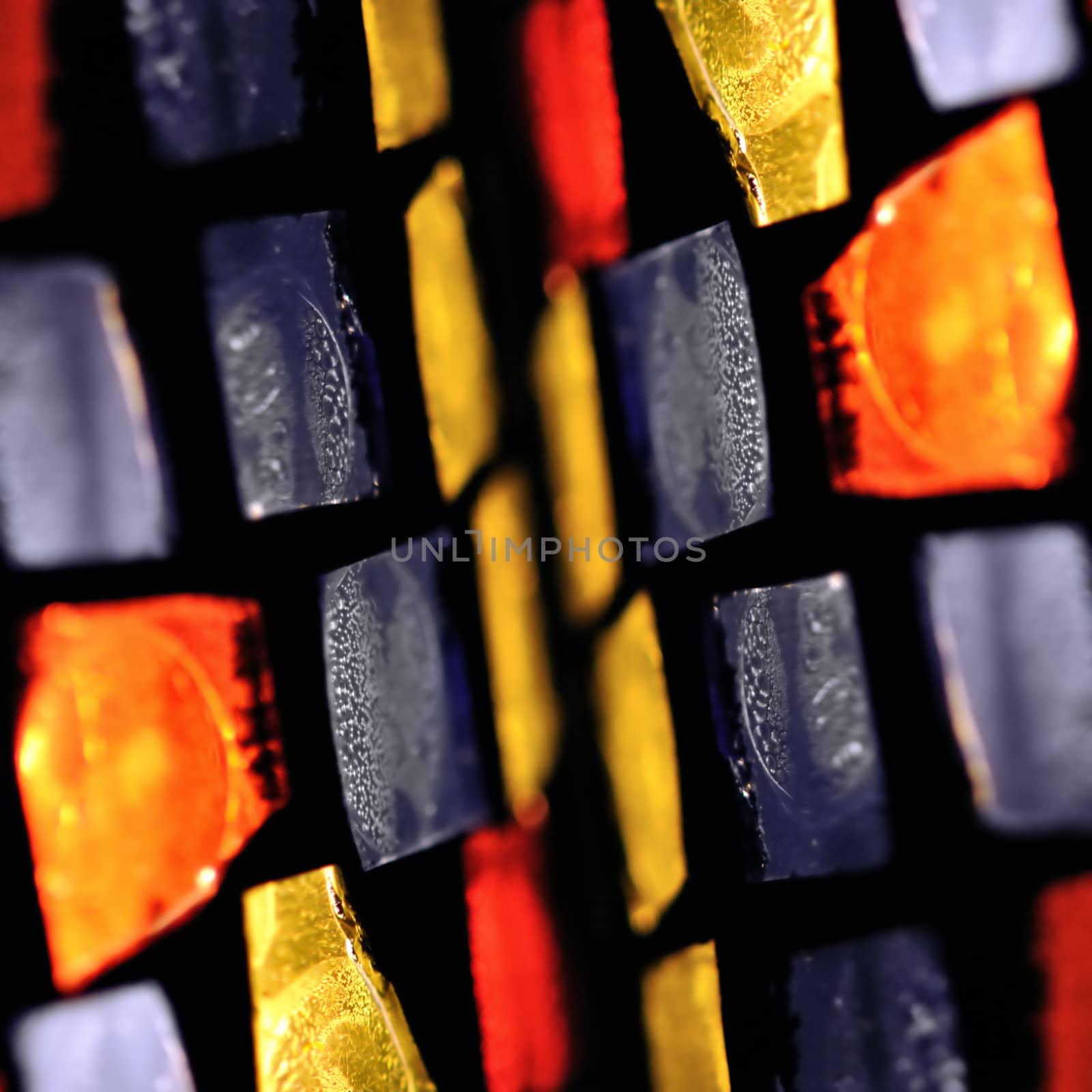 Colorful stained glass abstract illuminated squares. Selective focus.