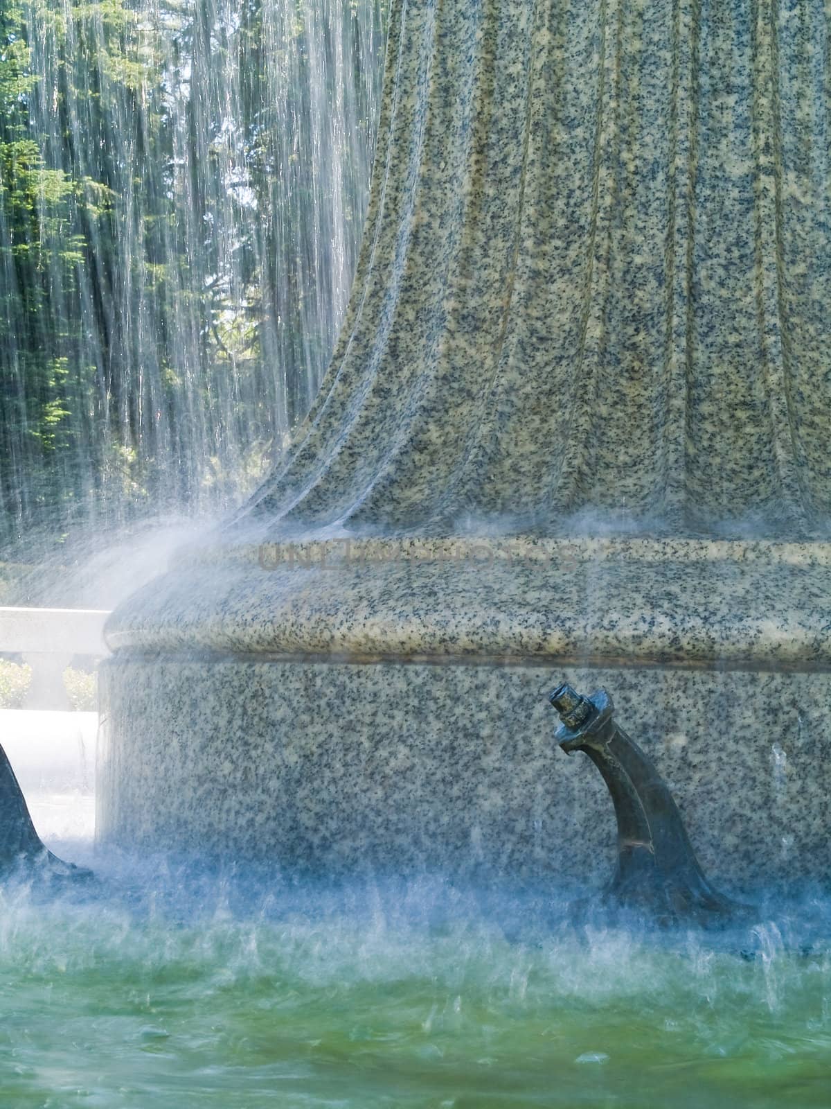 An Outdoor Park Fountain Spraying Water on a Sunny Day