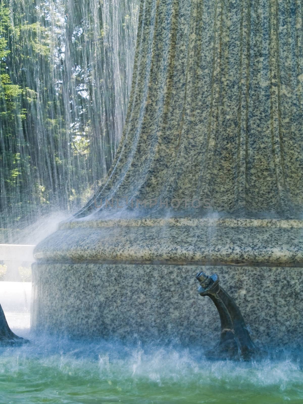 An Outdoor Park Fountain Spraying Water on a Sunny Day