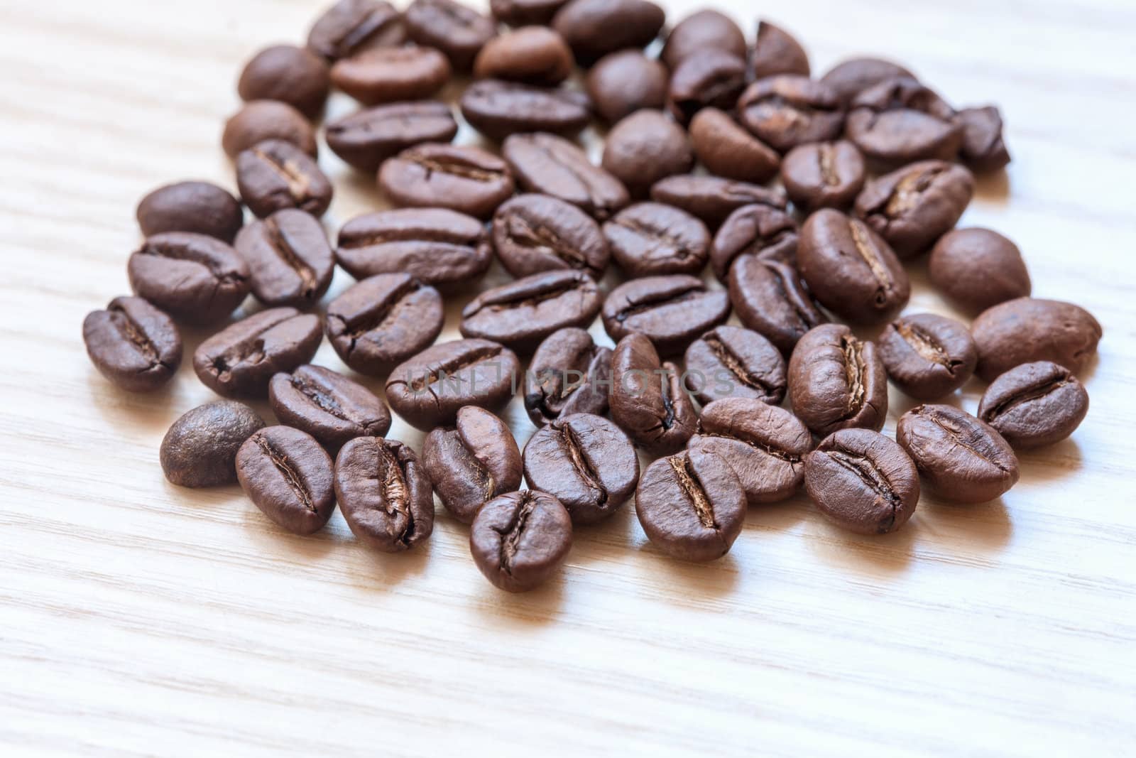 coffee beans on white wooden background by sfinks