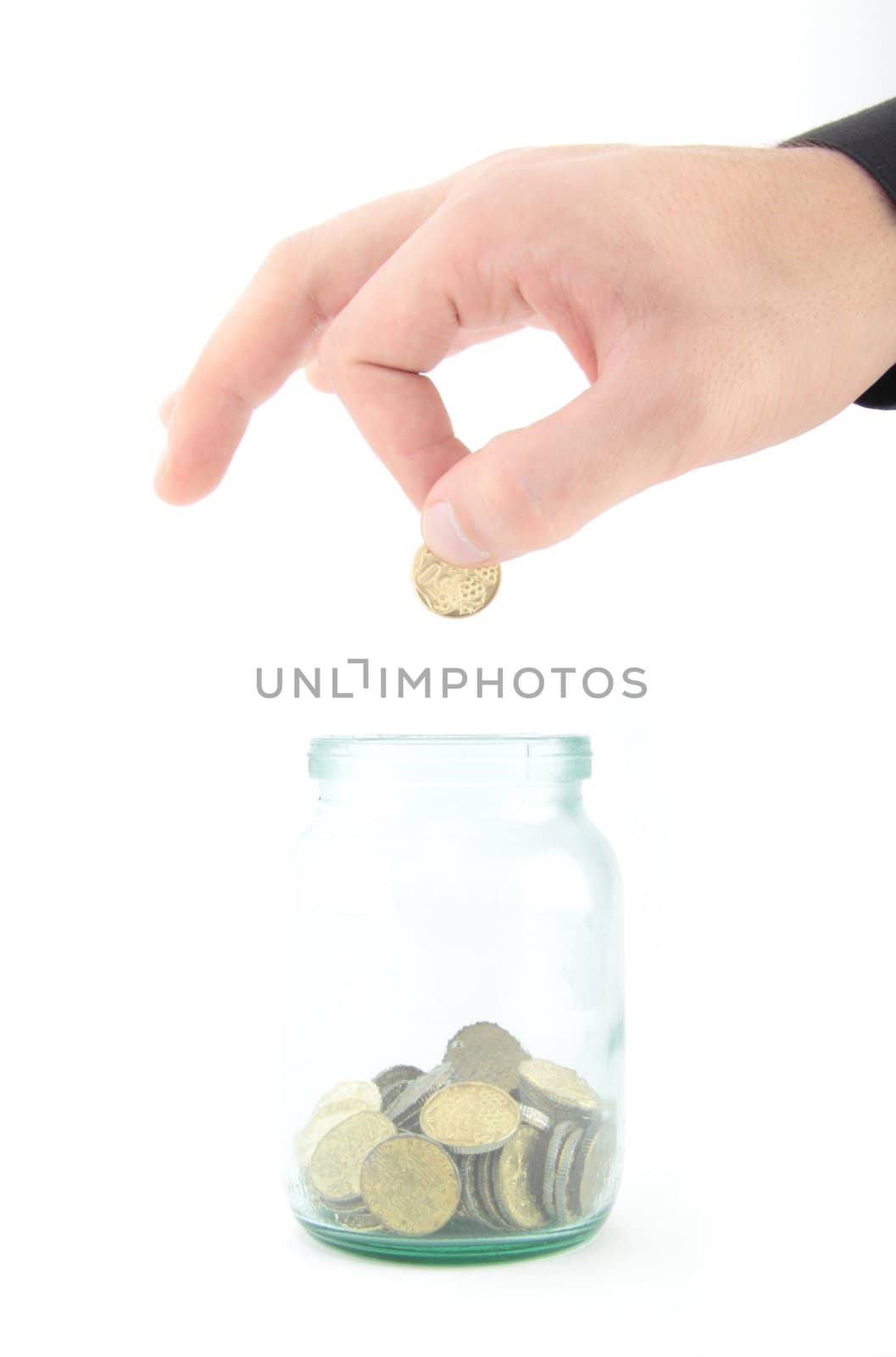 Close up of a man hand picking a coin in glass savings or tips bottle