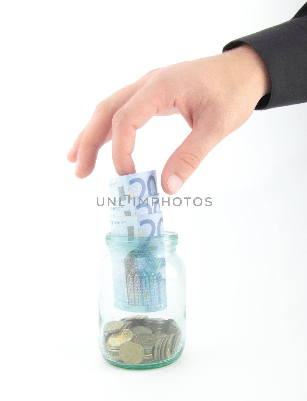 Close up of a man hand picking a euros out of a clear glass savings or tips bottle