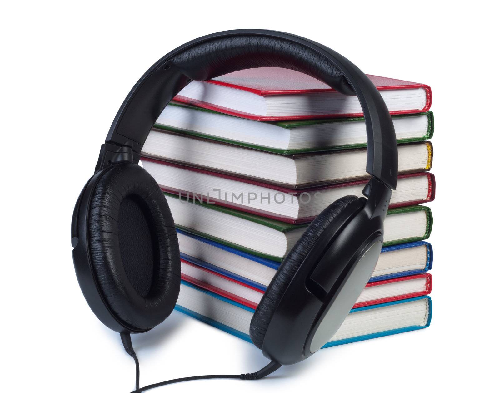 Headphones and stack of books isolated on white background.