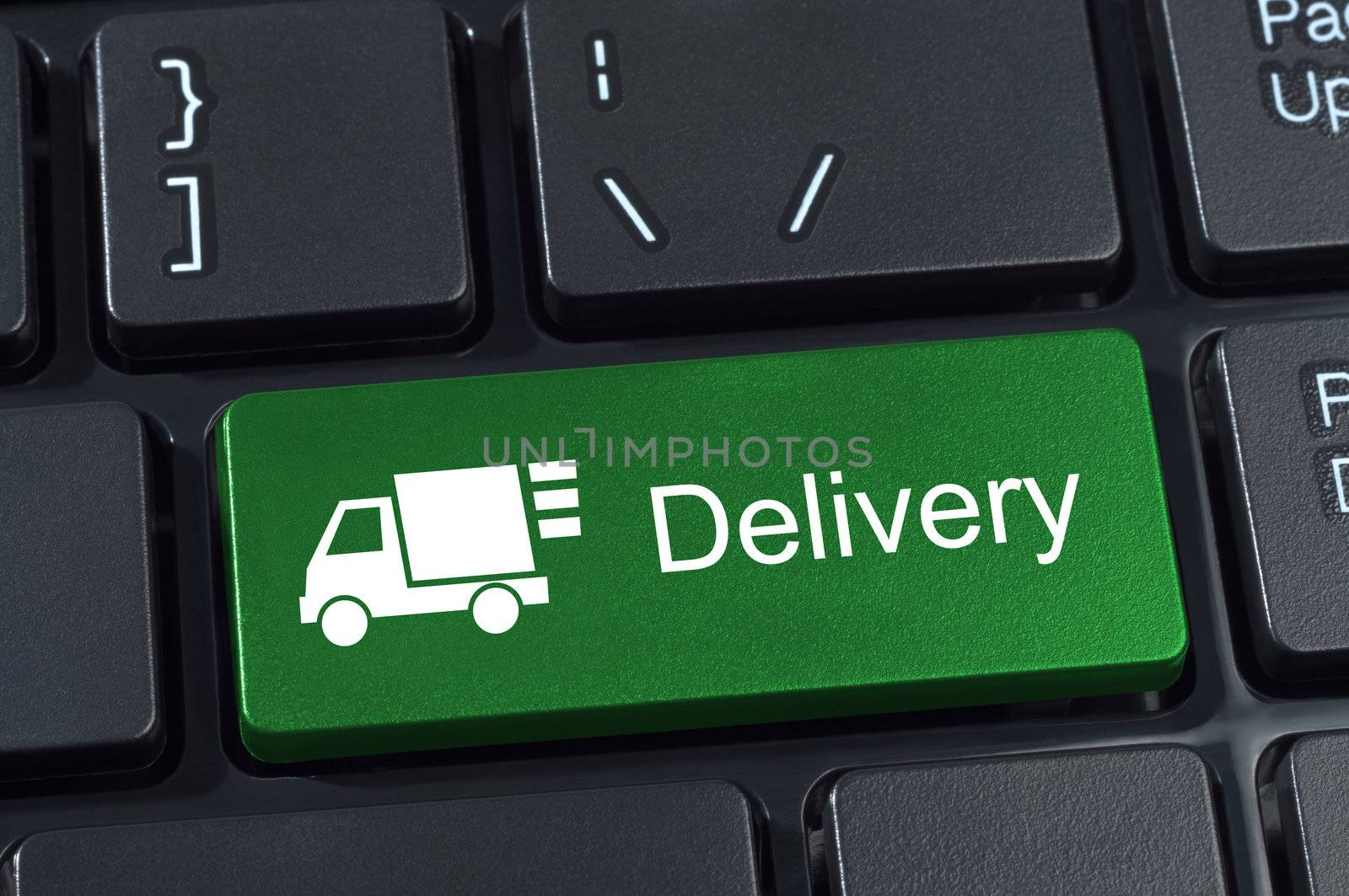 Keyboard button with truck icon and text delivery Internet concept.