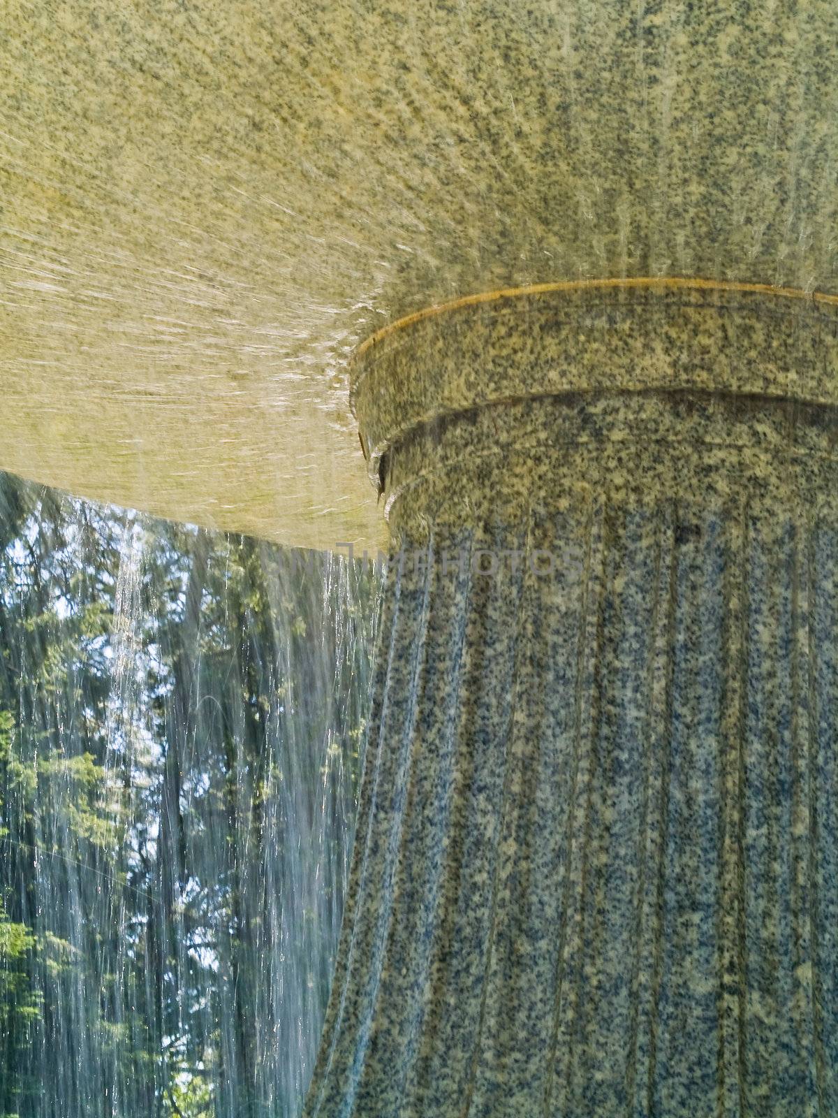 An Outdoor Park Fountain Spraying Water on a Sunny Day