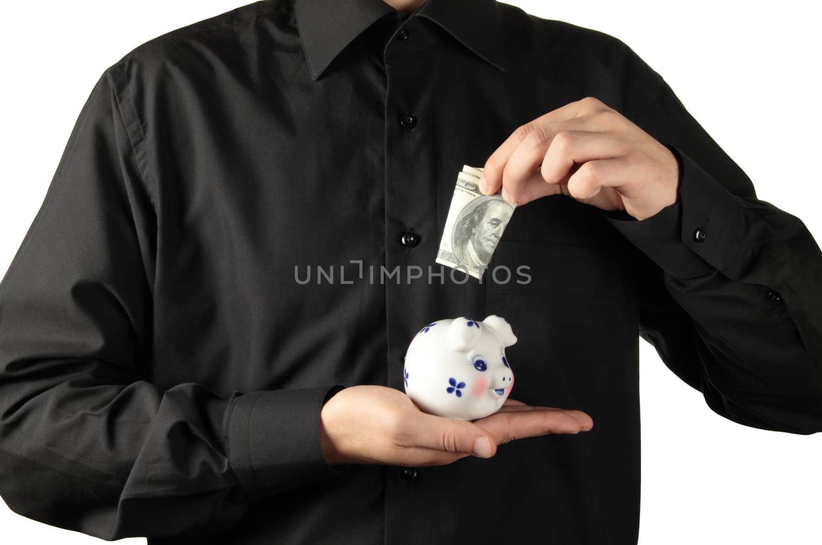Businessman gathering money into piggy bank concept
