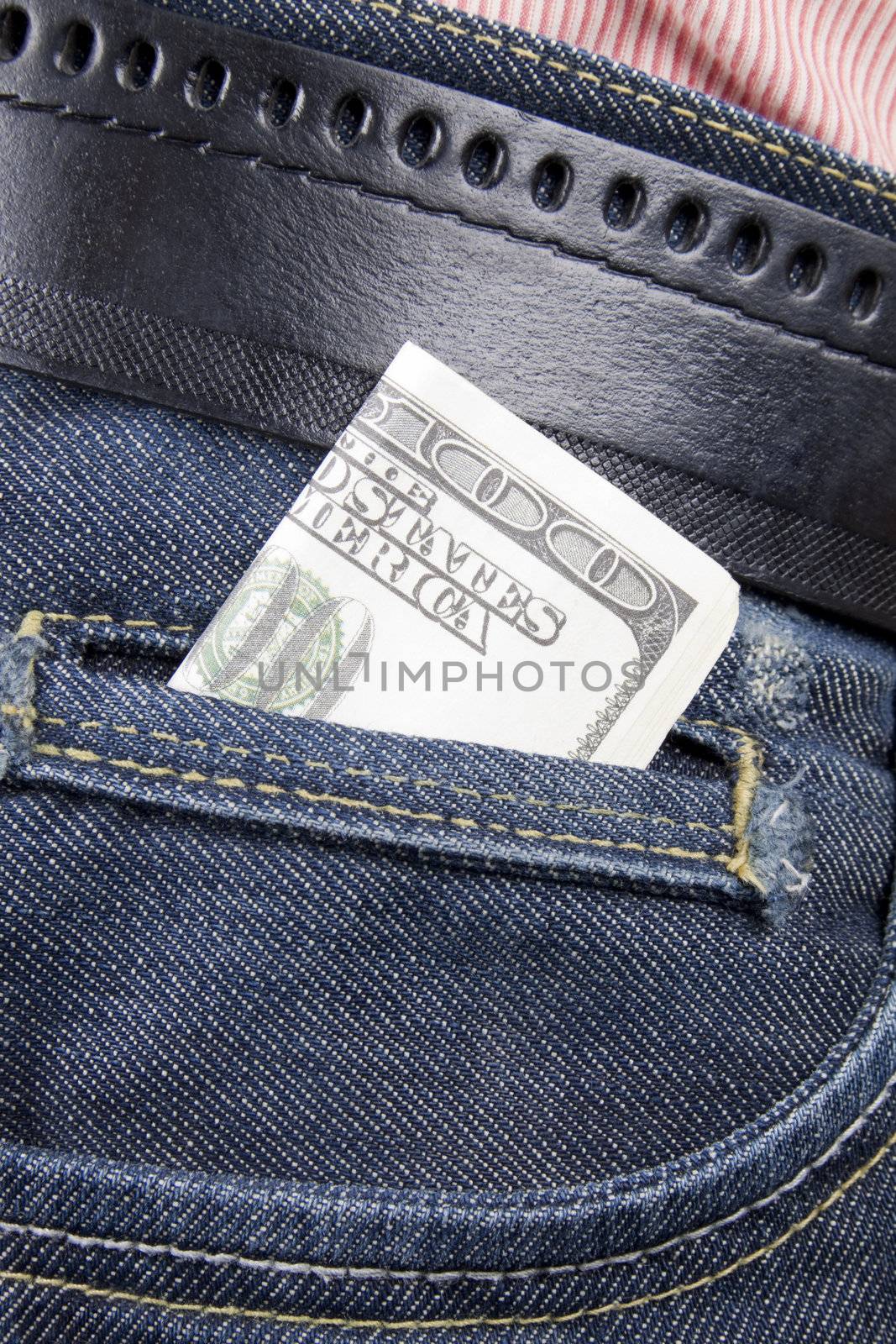 Stack of dollar bills in jeans pocket