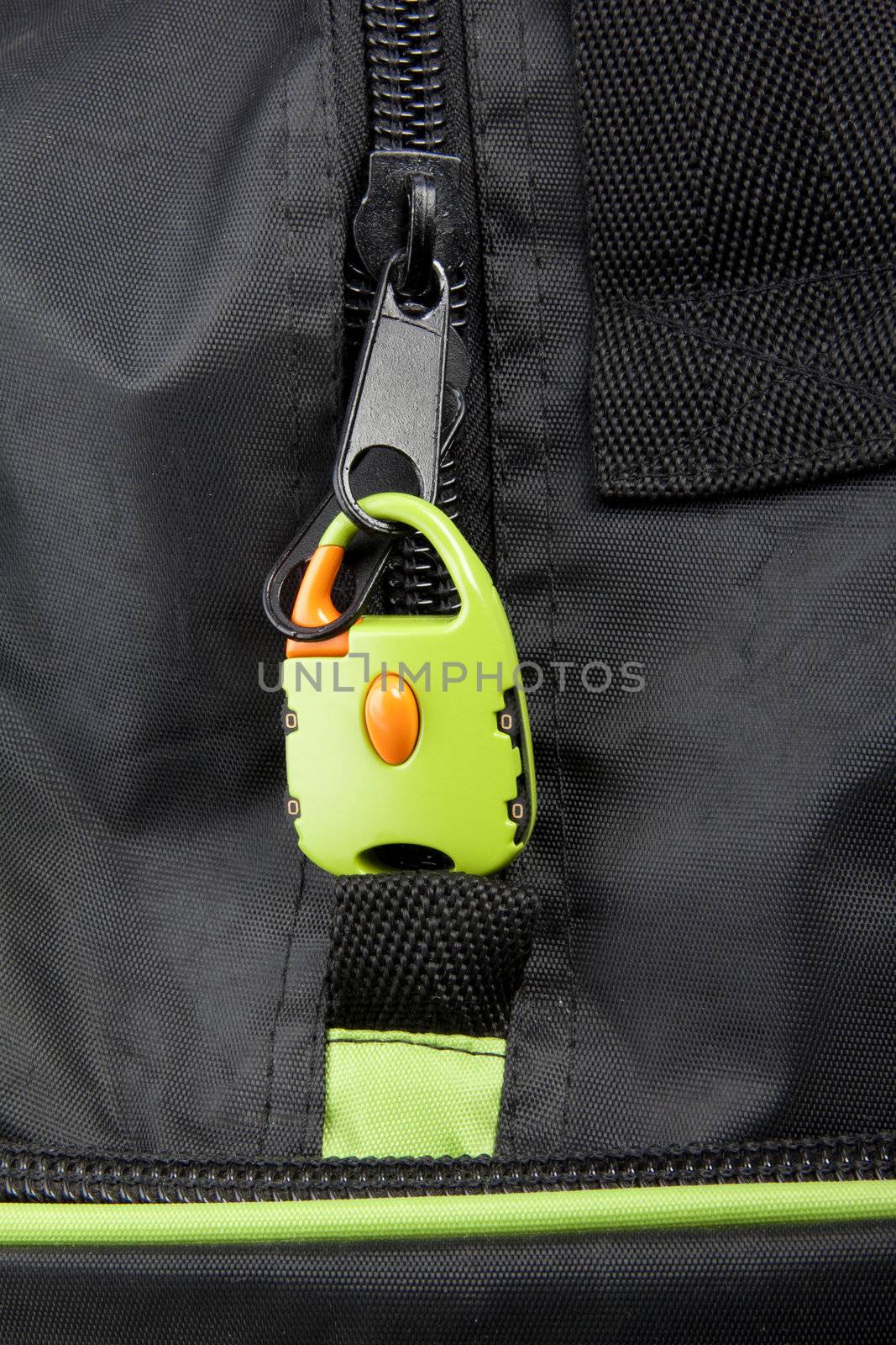 Green lock on a bag's zipper background