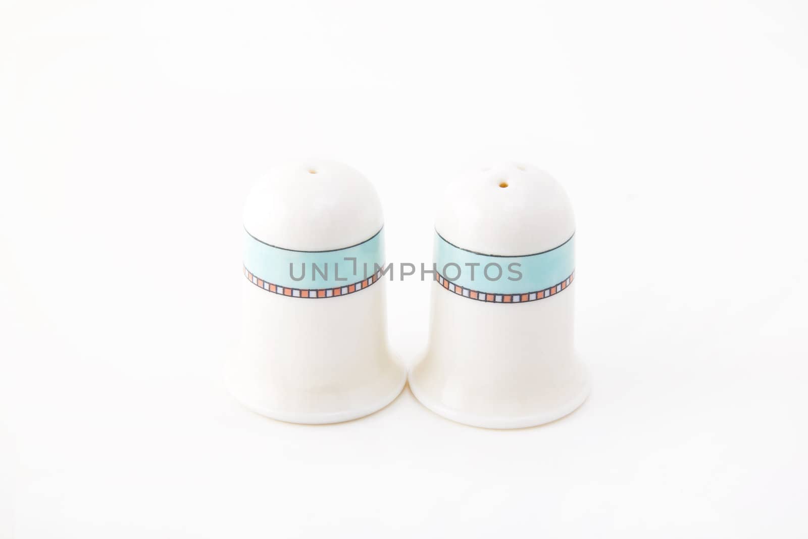 Closeup photograph of small silver and glass salt and pepper cellars