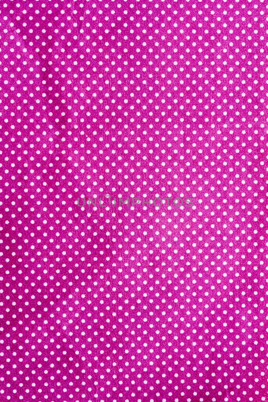 wrinkled purple cloth with a white dot