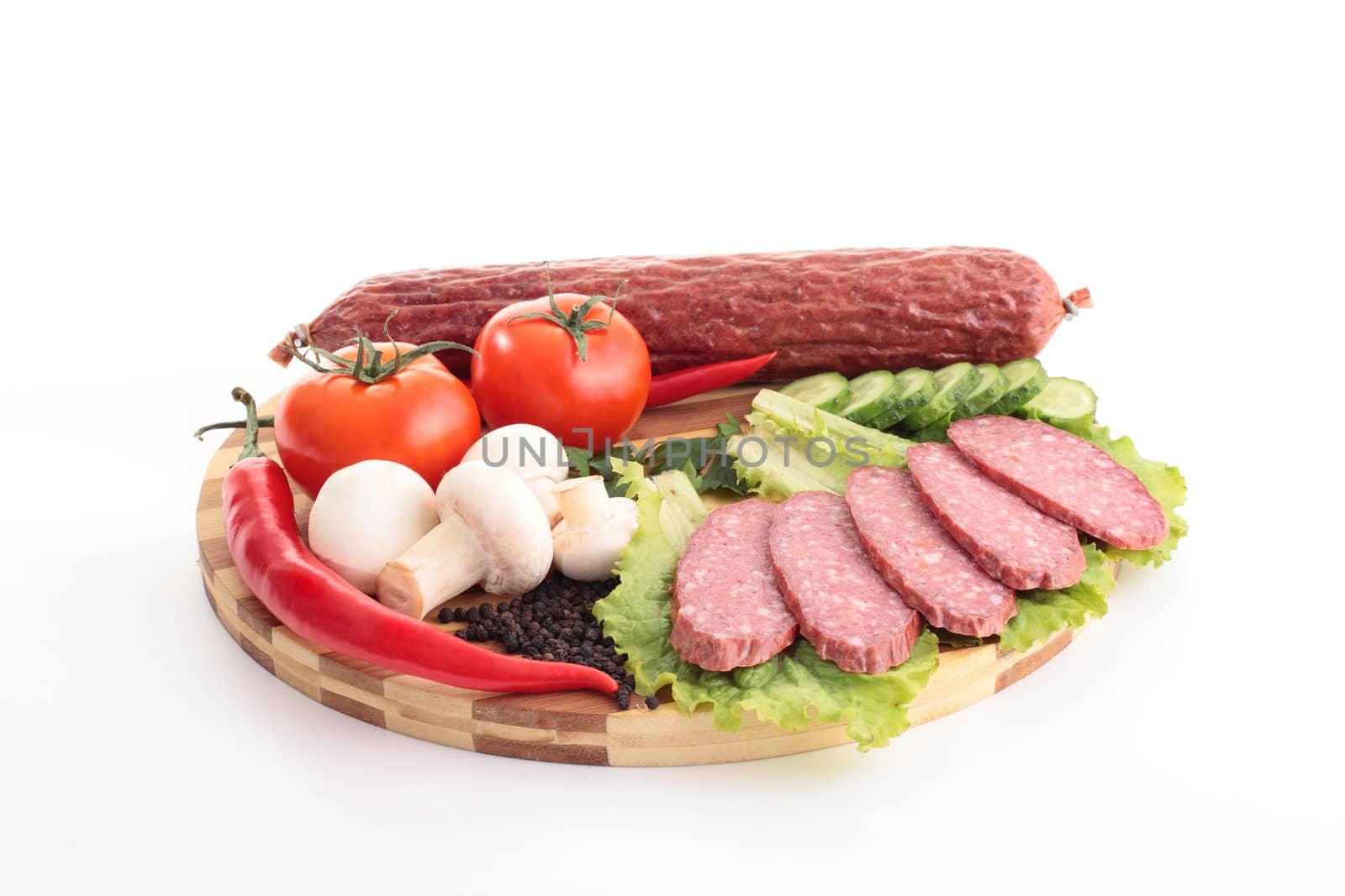 sliced sausage with vegetables on board by shutswis