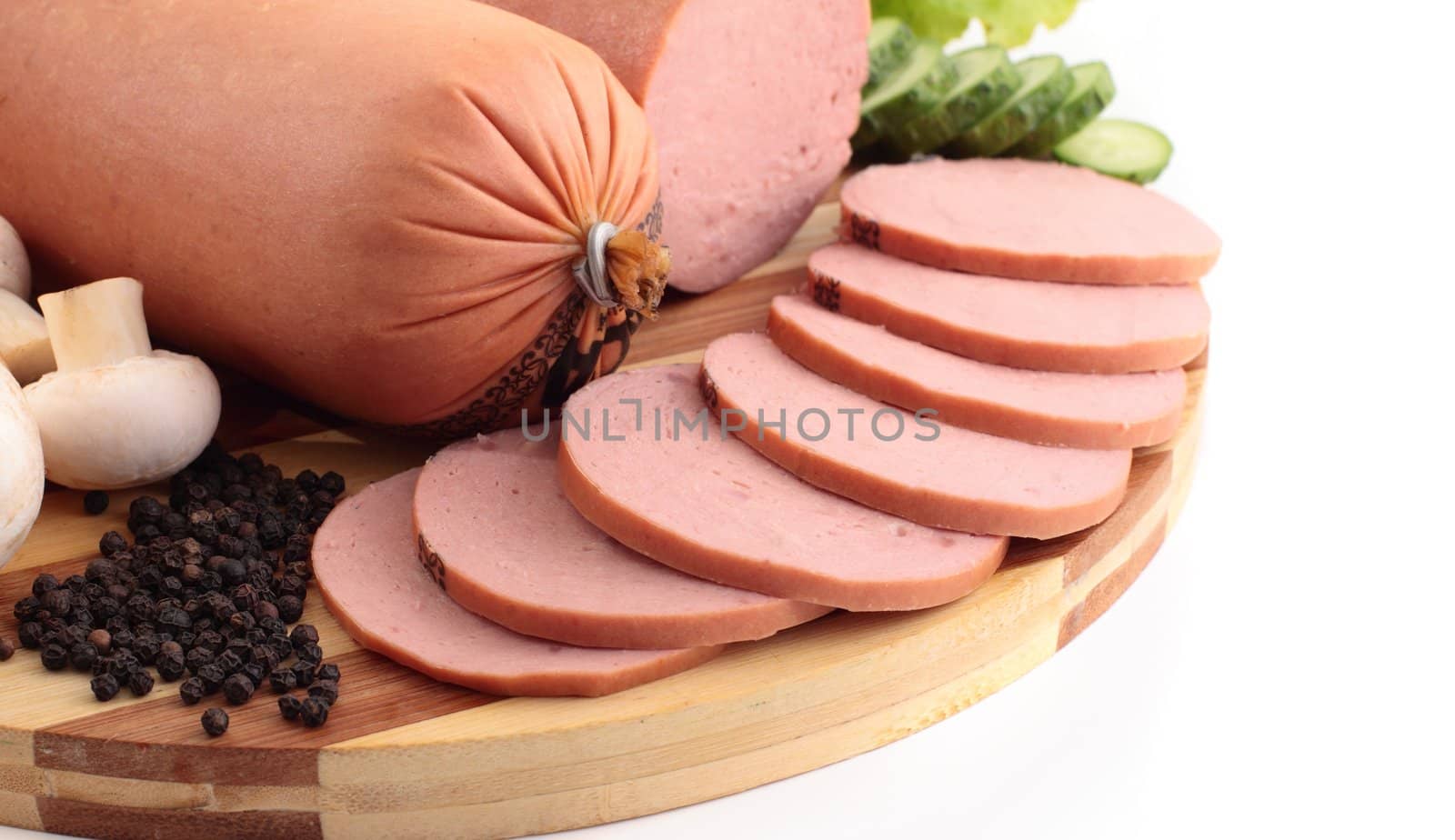 Sliced ham on a wooden board isolated on white