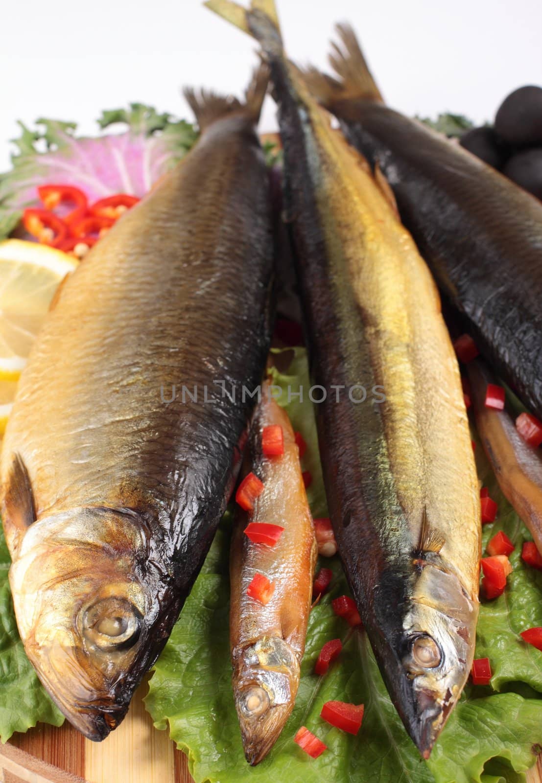 fish on plate with red pepper isolated on white