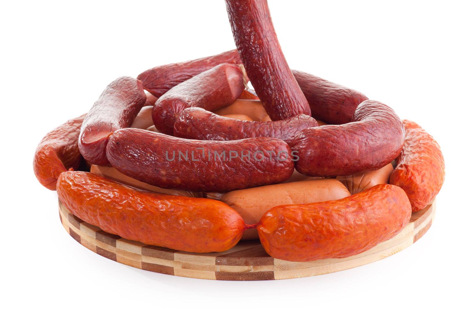 various sausages on wooden plate isolated on white