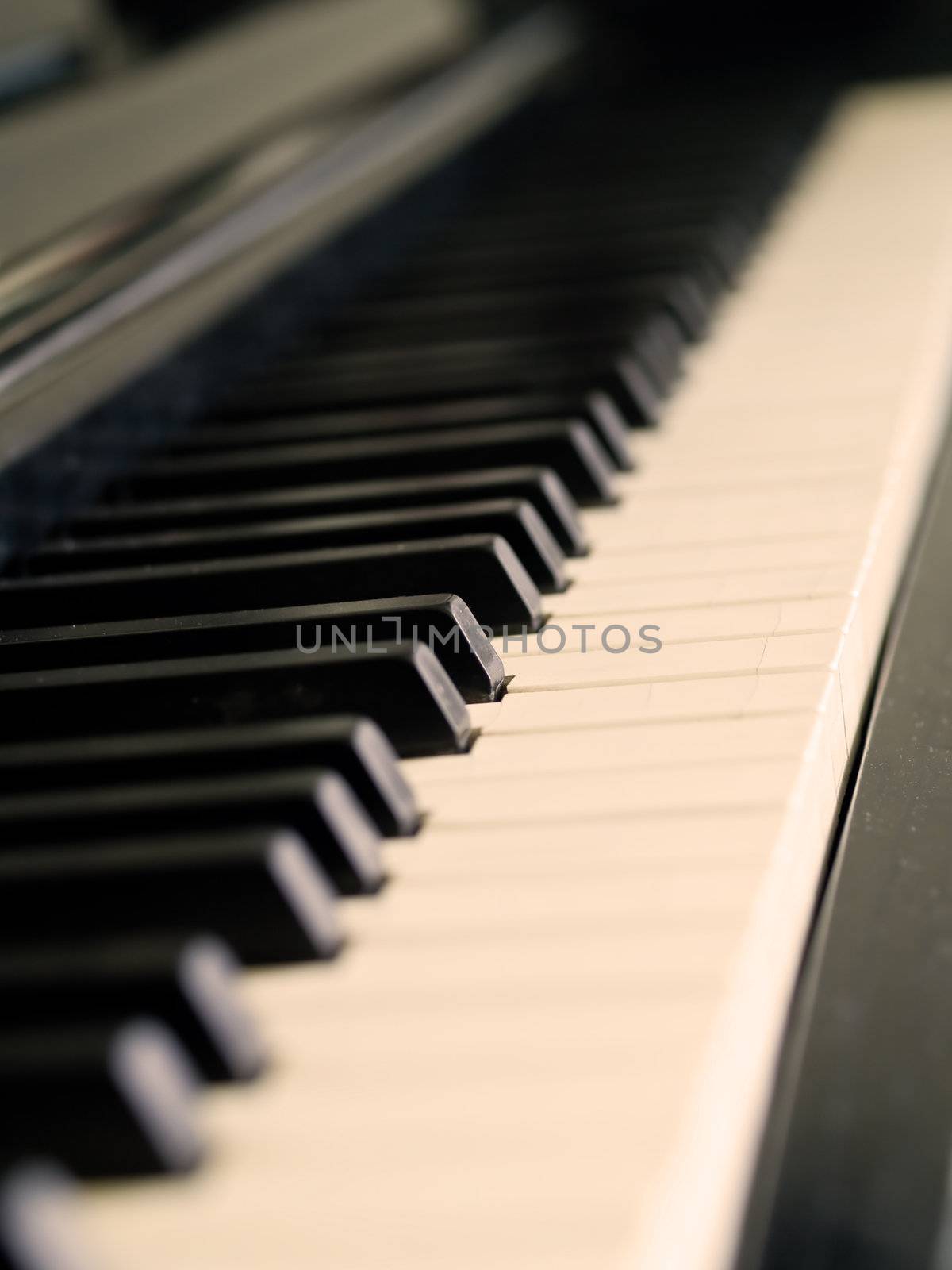 Piano keys of a very well loved and often played piano 