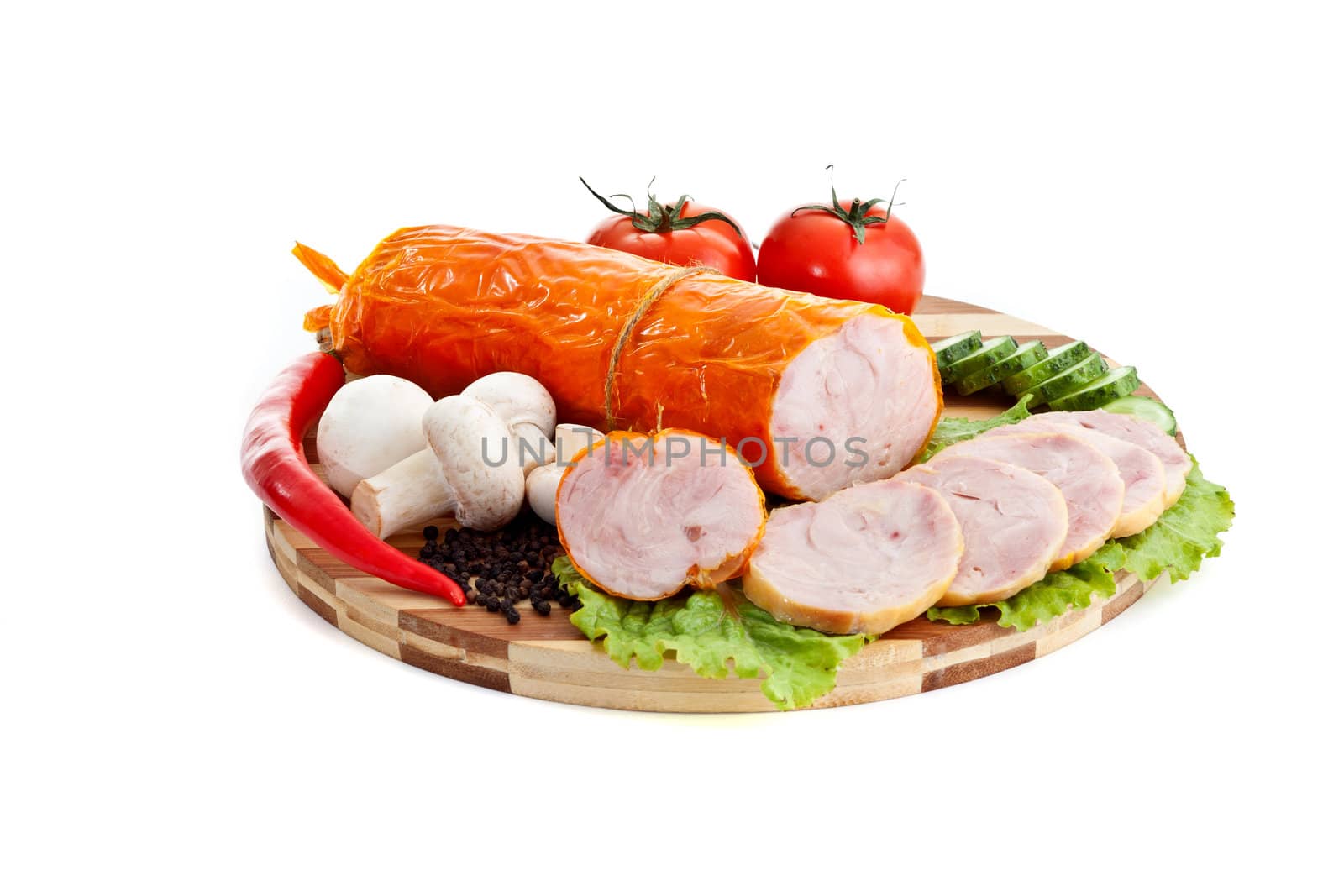 sausages in coposition with vegetables isolated on white