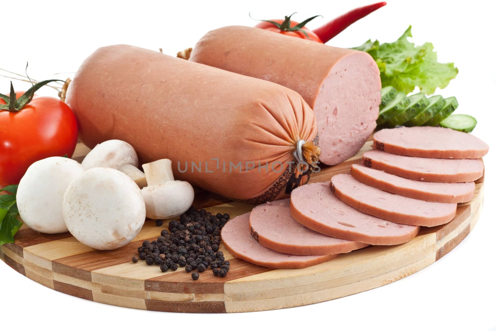 sausage on plate with vegetables isolated on white