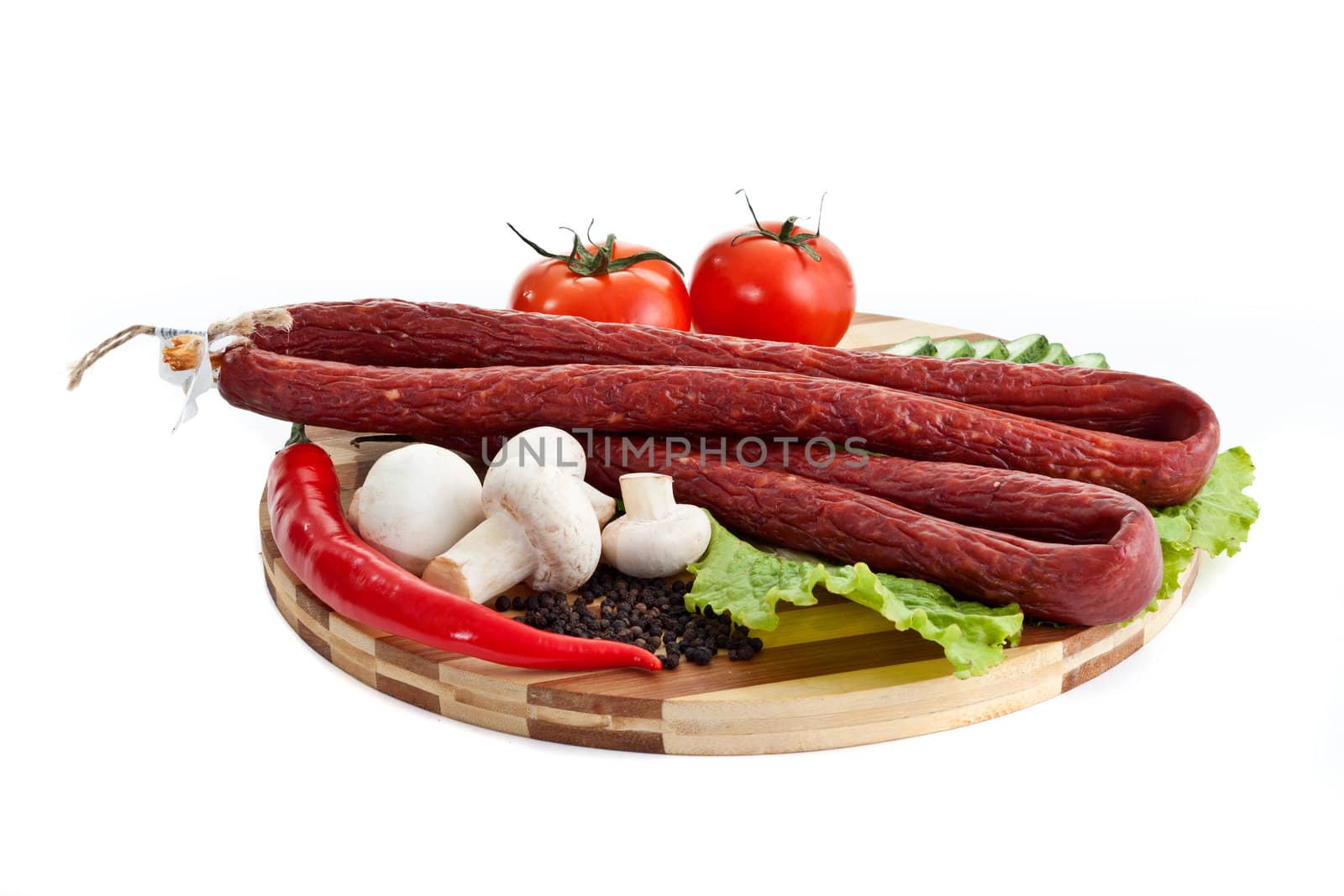 sausages in coposition with vegetables isolated on white