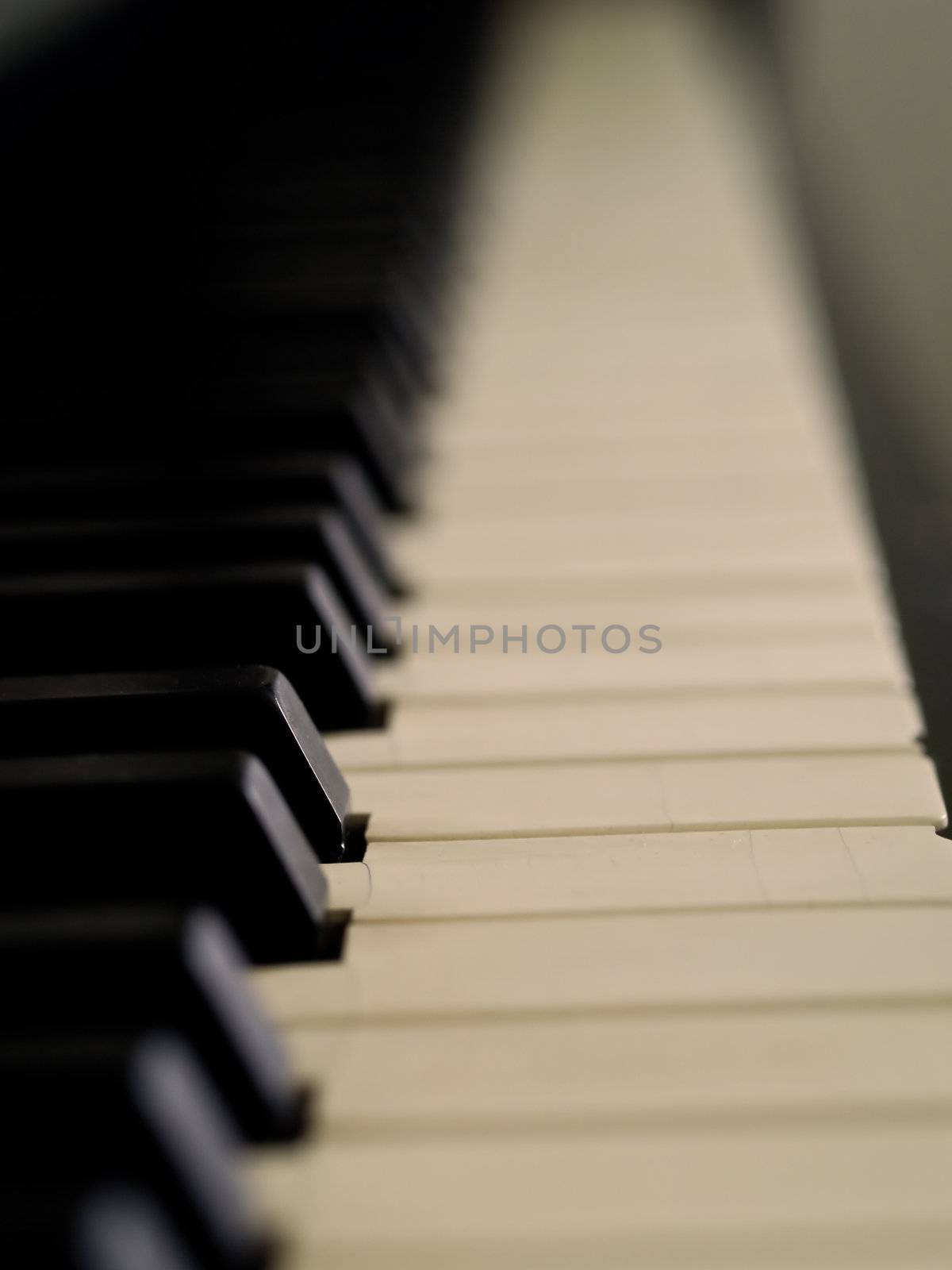 Piano keys of a very well loved and often played piano in Sepia